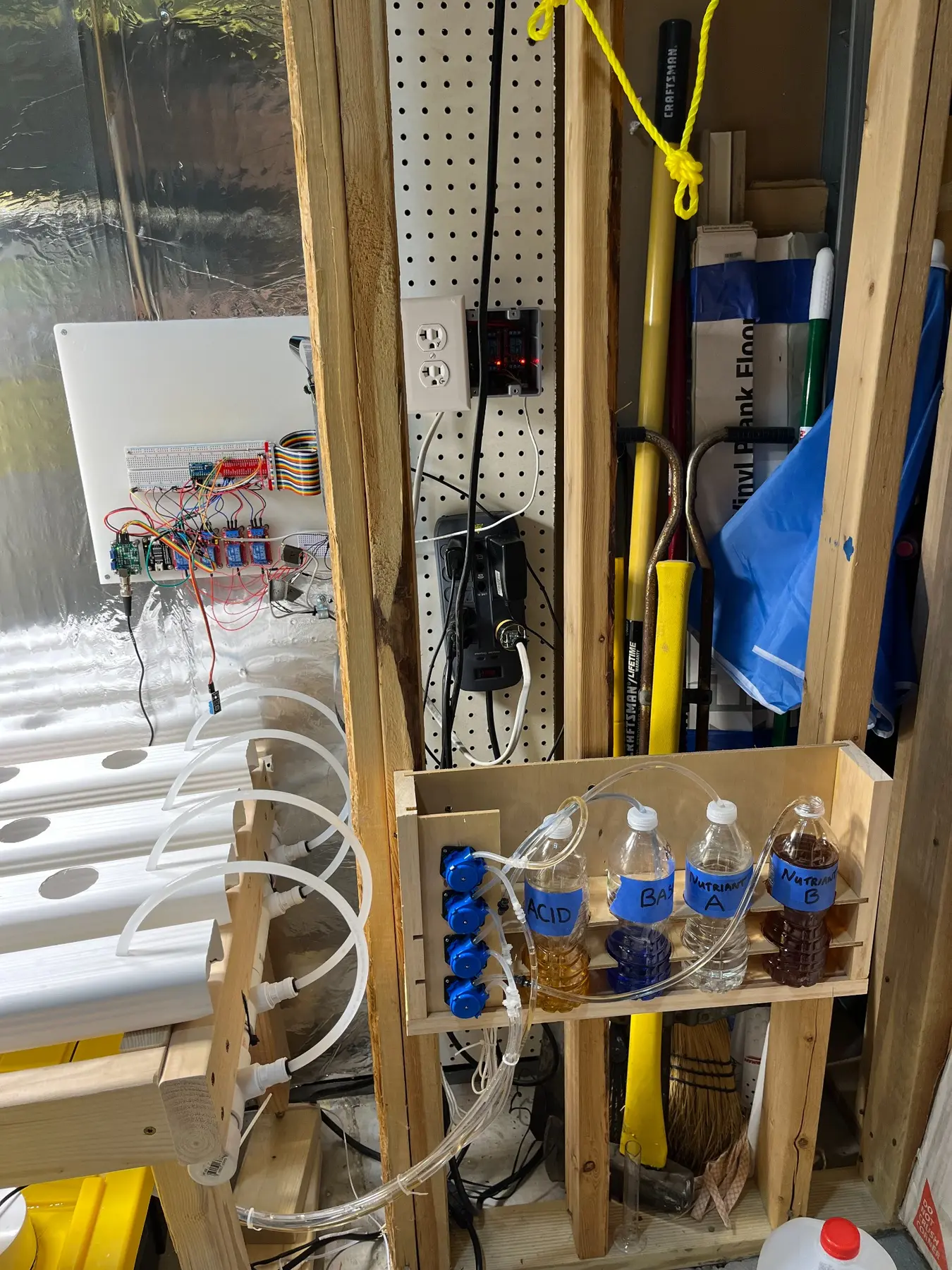 Early hydroponic controller with relay modules and four dosing pumps connected to nutrient and pH bottles